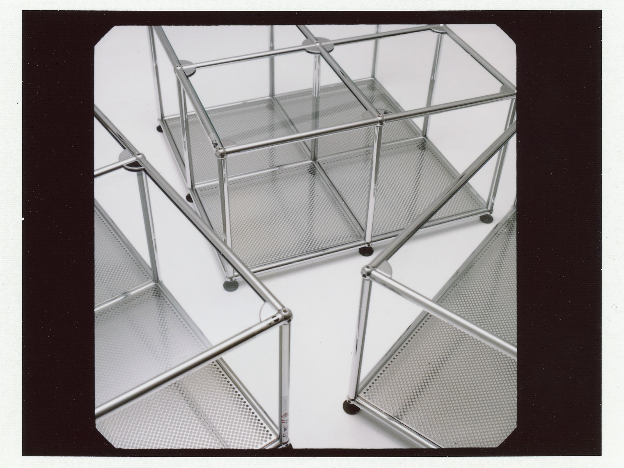 USM Haller chrome furniture frames arranged on a white studio surface