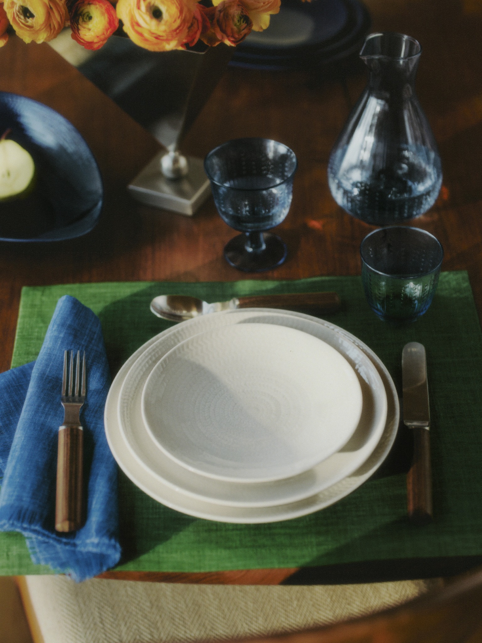 White Rörstrand tableware with glassware and flowers for the 300-year anniversary campaign