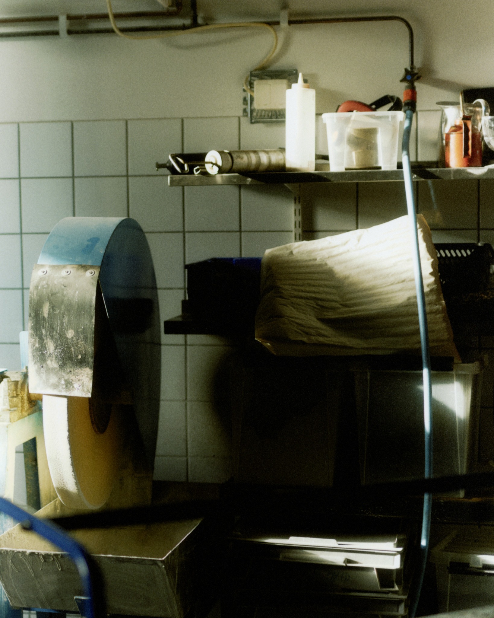 Sunlit machinery and shelves inside a workshop