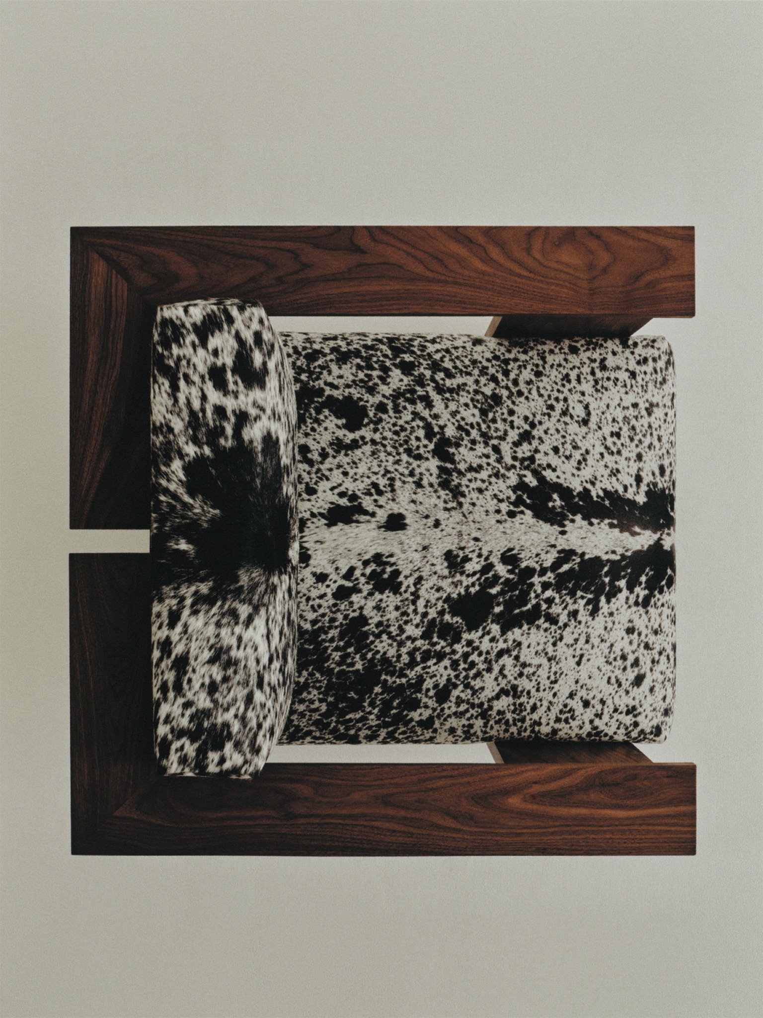 Top view of a Gaucho chair with dark wooden arms and black-and-white cowhide upholstery for Nordiska Galleriet